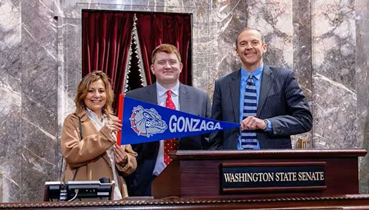 President Passerini pose with a Gonzaga flag along with Zag student and state senator President Passerini pose with a Gonzaga flag along with Zag student and state senator