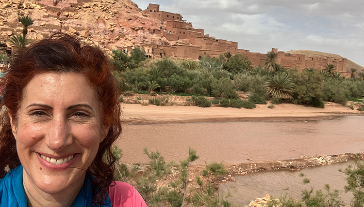 Professor Juliane Mora in front of ancient buildings in Morocco