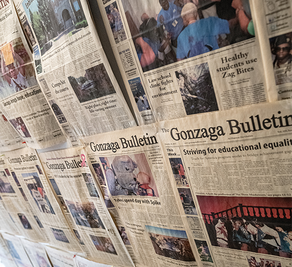 A bunch of old Bulletin's hanging on the wall.